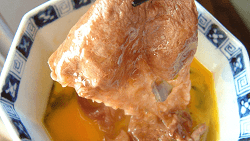 Dip sukiyaki beef into raw egg